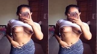 Young woman takes sexy photos of her breasts for her boyfriend