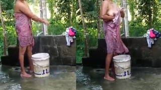 Bathing in the open air: A girl's outdoor bath in the village