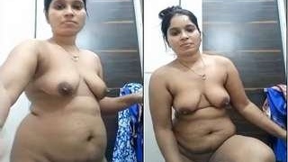 Watch a bhabhi strip and flaunt her body in a steamy video