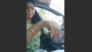 Busty Indian babe gives a car blowjob