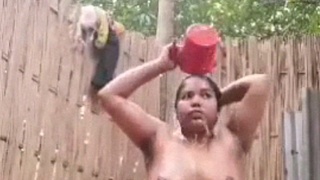 Nude Indian aunt bathes in the outdoors
