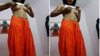 A young girl strips down and attempts to wear a revealing skirt in front of the camera