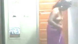 Watch an Indian aunt undress in a secret camera video